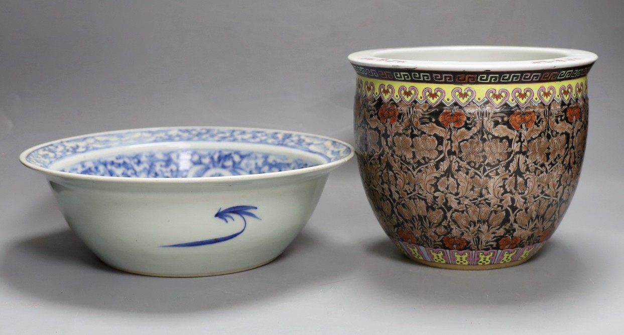 A 19th century Chinese blue and white basin and a famille rose jardiniere. Basin 29cm diameter